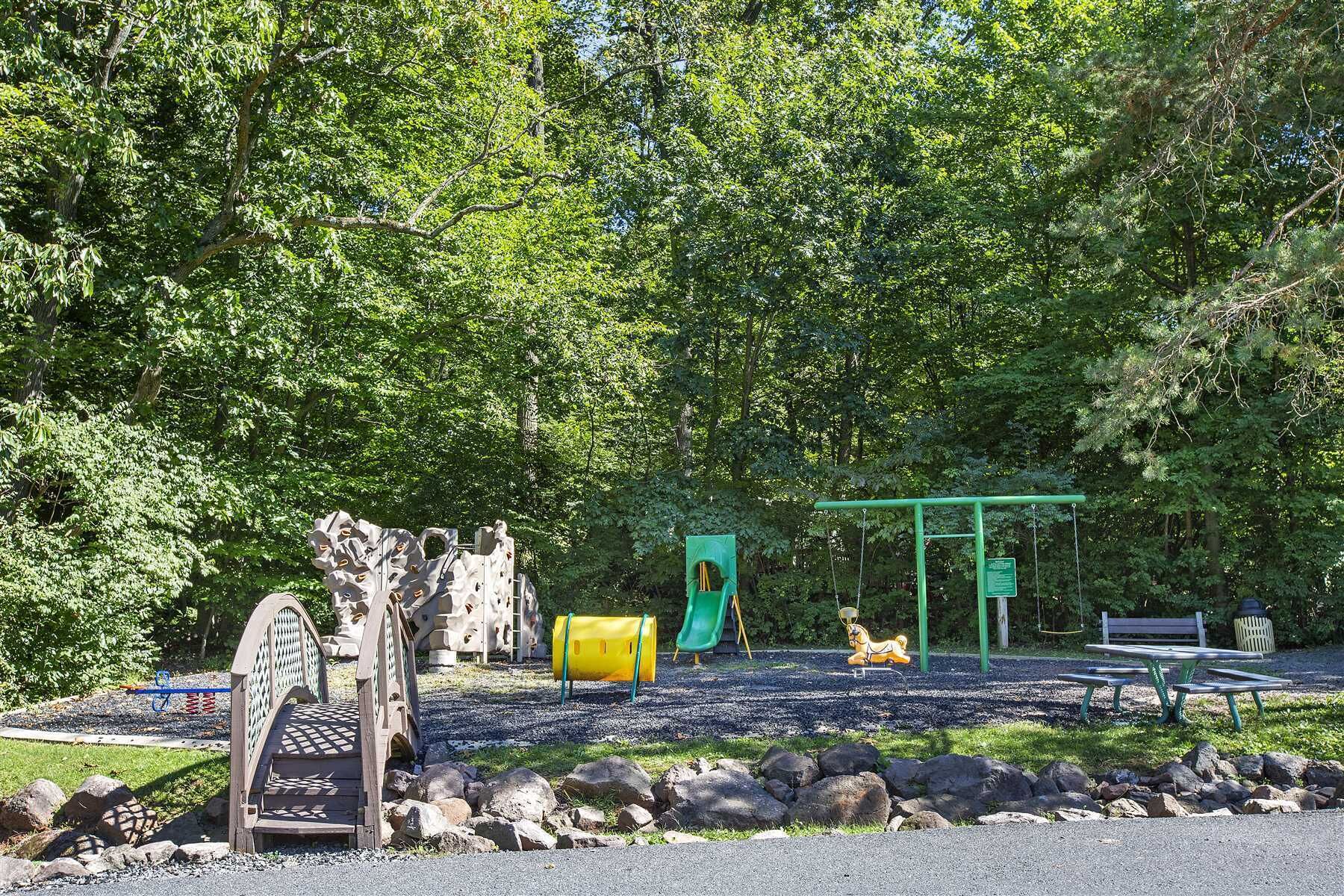 A playground with a slide, swings, and a climbing structure.