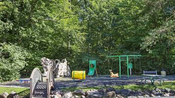 A playground with a slide, swings, and a climbing structure.
