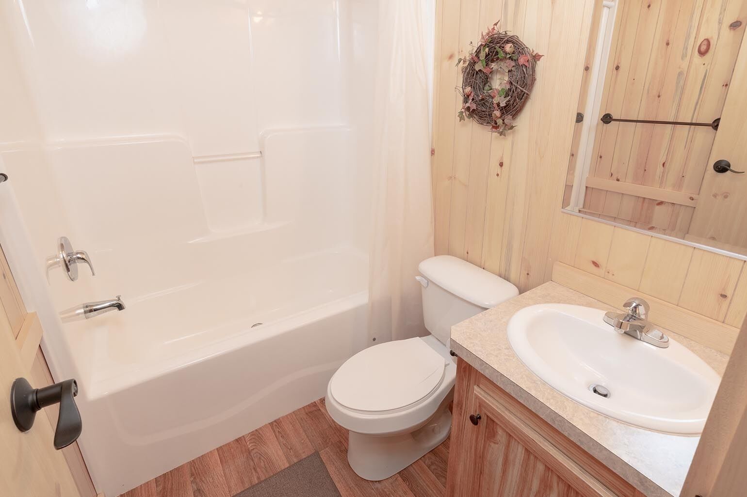 A bathroom with a bathtub, toilet, and sink.