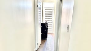 A narrow hallway with wooden flooring and white walls. - Modern 3 bed, 2 bath townhouse. (Vaughan)