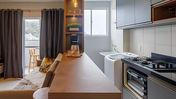 A modern kitchen with a built-in stove, a coffee maker, and a sink.
