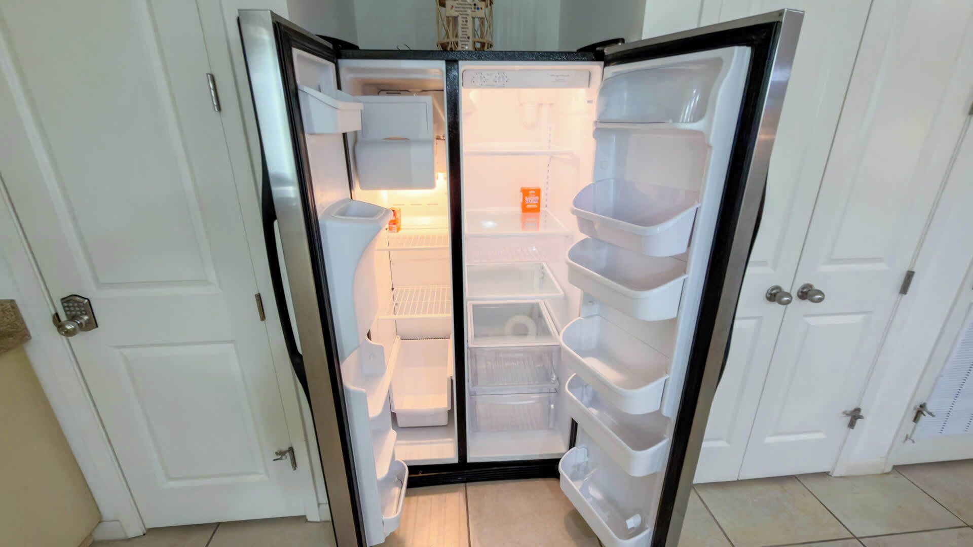 A walk-in refrigerator with multiple shelves and a freezer compartment.