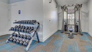 A gym with weightlifting equipment, a dumbbell rack, and a squat rack. - Cozy Stay 8mins to Old Town Scottsdale (Scottsdale)