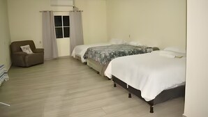 A bedroom with a single sofa, two beds, a window with curtains, and a ceiling vent. - Private Family Country Home in Usulutan, El Salvador (Usulutan)