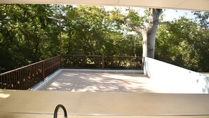 A balcony with a metal railing, a sink, and a view of trees. - Private Family Country Home in Usulutan, El Salvador (Usulutan)