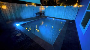 A swimming pool with a wooden deck and a chair. - Steps to Beach Private Pool 2 Big Levels (South Padre Island)