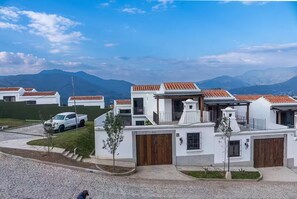 A residential area with white houses, red-tiled roofs, and a mountainous backdrop. - Hermosa casa colonial cerca del centro de Antigua (Ciudad Vieja, San Pedro Las Huertas)