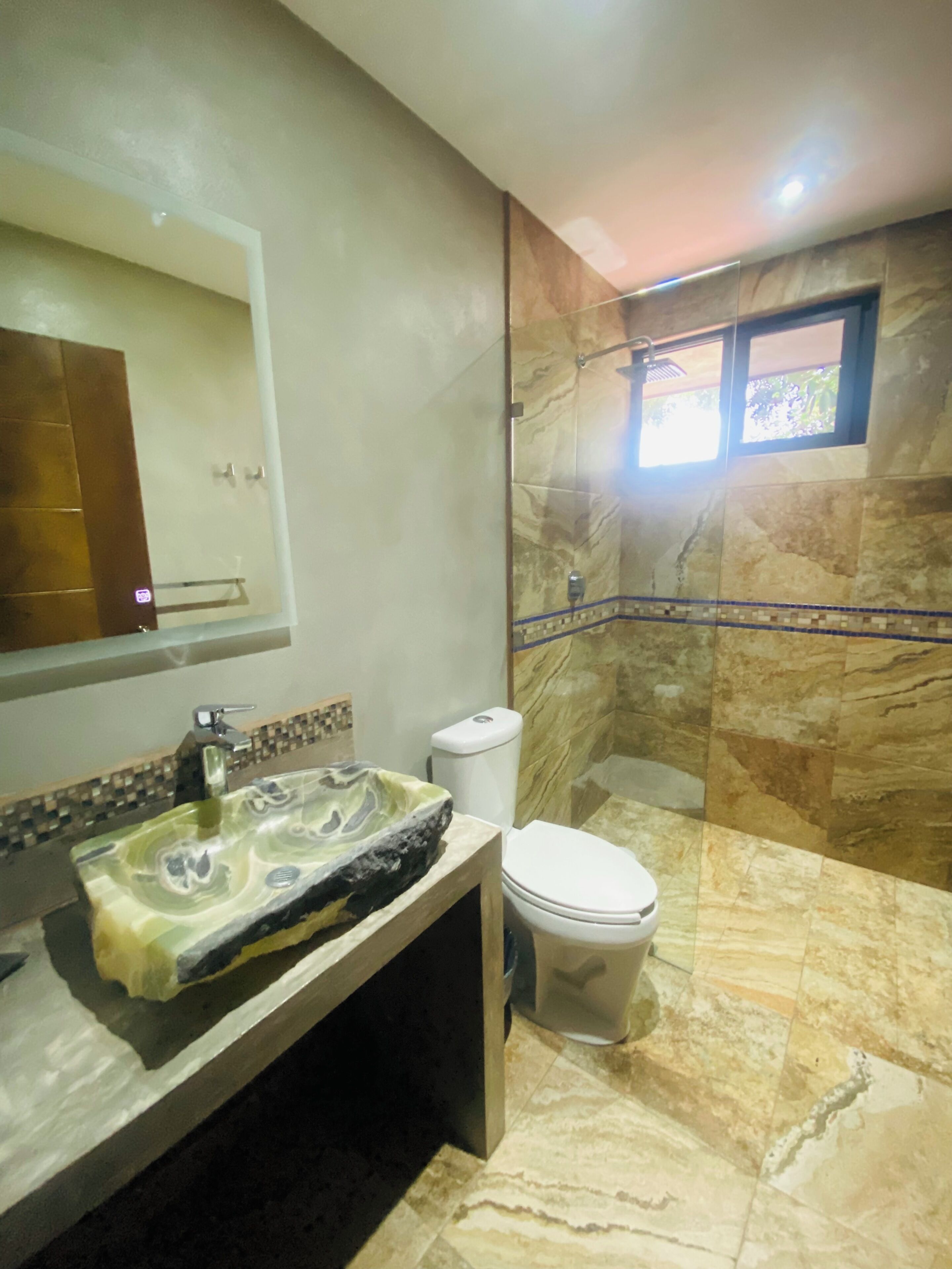 C1 - Deluxe Quadruple Room, Patio, Garden View | Bathroom | Shower, rainfall showerhead, towels, soap