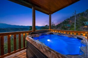 A hot tub on a wooden deck with a view of a mountainous landscape at dusk. - Smokies Twin Rock-Views, Game Room, Hot Tub& More (Sevierville)