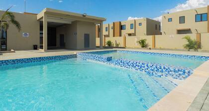 Cozy 3-bedroom/ bathroom house in Portmore with AC, pool, and gym access