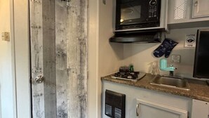 A compact kitchen with a microwave, a coffee maker, and a sink. - StayNow @ The Mini Escape between New Braunfels & Canyon Lake (New Braunfels)