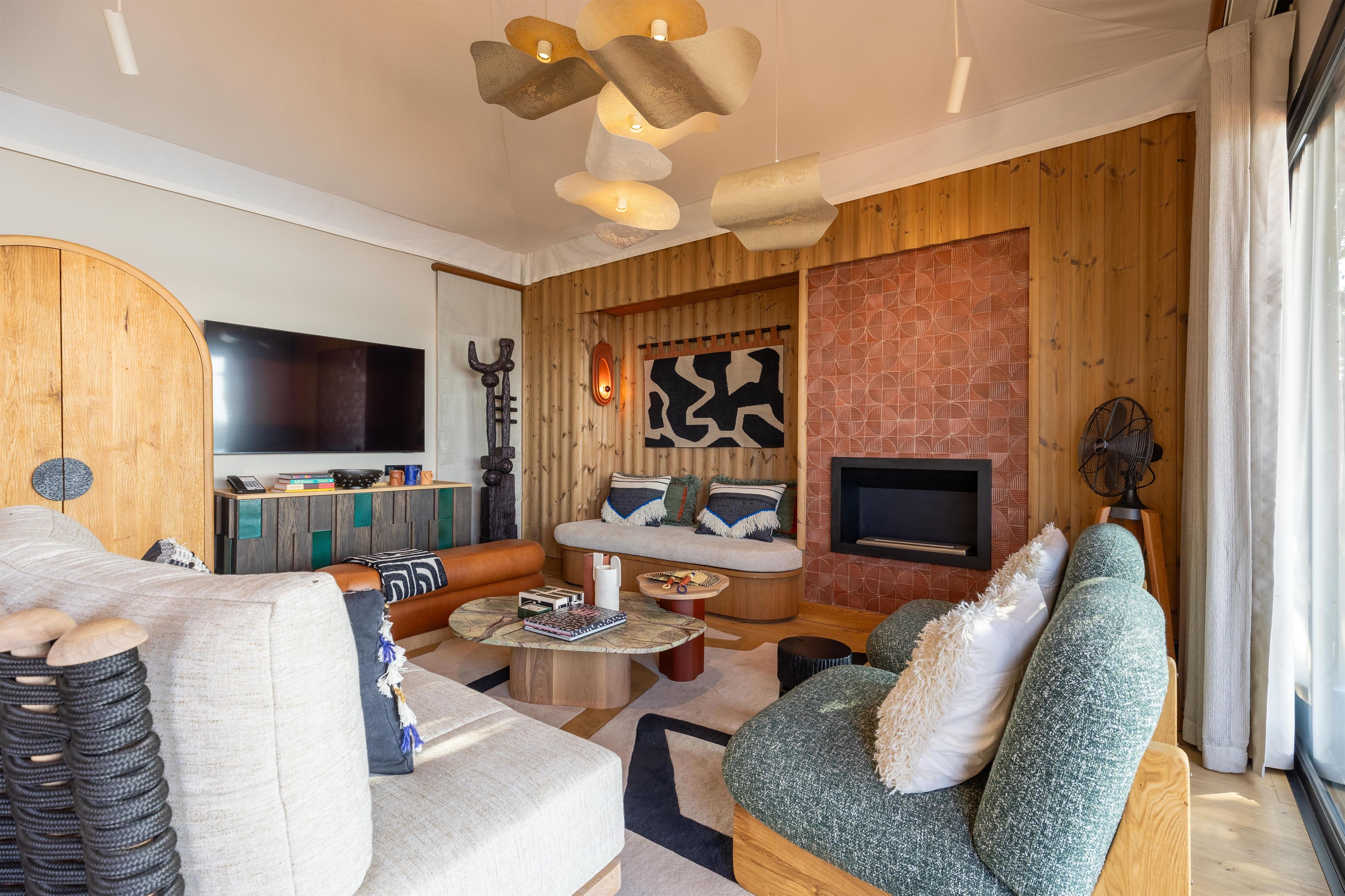 Una sala de estar moderna con una pared de madera, una chimenea y un televisor de pantalla plana.