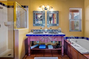 A bathroom with a double sink, two mirrors, a vanity, a bathtub, and a shower enclosure. - King studio suite:  hot tub & breakfast (Sedona)