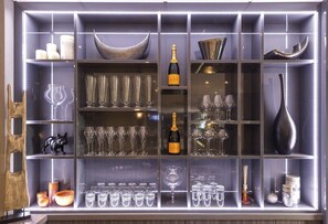 A well-organized display of glassware and decorative items in a bar setting. - Kyriad Saint Quentin (Saint-Quentin)