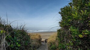A coastal path leading to a beach with ocean views. - Rockaway Beach Oceanfront Views! Private Balcony, Beachfront Paradise! (Rockaway Beach)