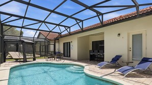 A swimming pool with lounge chairs and a covered patio area. - Epic Princess and Villains Hideaway-  Private Pool  Themed Rooms  Near Disney (Kissimmee)
