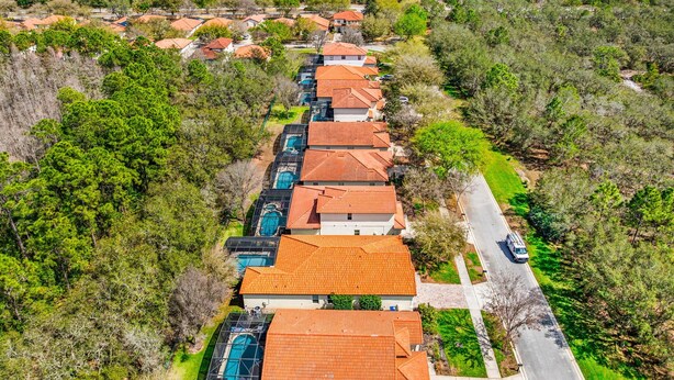 A residential area with houses featuring red-tiled roofs, surrounded by dense greenery. - Epic Princess and Villains Hideaway-  Private Pool  Themed Rooms  Near Disney (Kissimmee)