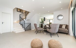 A modern living room with a staircase, a sofa set, and a dining area. - Gorgeous home in Mlini with sauna (Mlini)