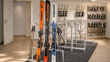 Un magasin de matériel de ski où l’on peut voir des skis et des bâtons de ski exposés sur des présentoirs.