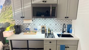 A compact kitchen with a microwave, sink, and a small refrigerator. - Near Airport, Hospital, Midtown, 58 TV - Apt 254 (Reno)