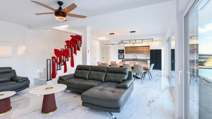 A modern living room with a sectional sofa, a dining area, and a kitchen. - Pet friendly home in Jadranovo with sauna (Jadranovo)