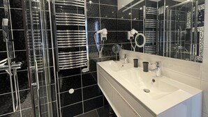 A modern bathroom with a large mirror, two sinks, and chrome towel racks. - AMOUR AMOUR - Apartment Héliopolis K 209 - Luxe - 4 people (AGDE)