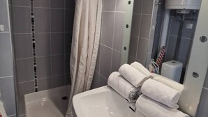 A modern bathroom with a shower, a sink, and a mirror. - Studio Héliopolis L 20 - 2 people (AGDE)