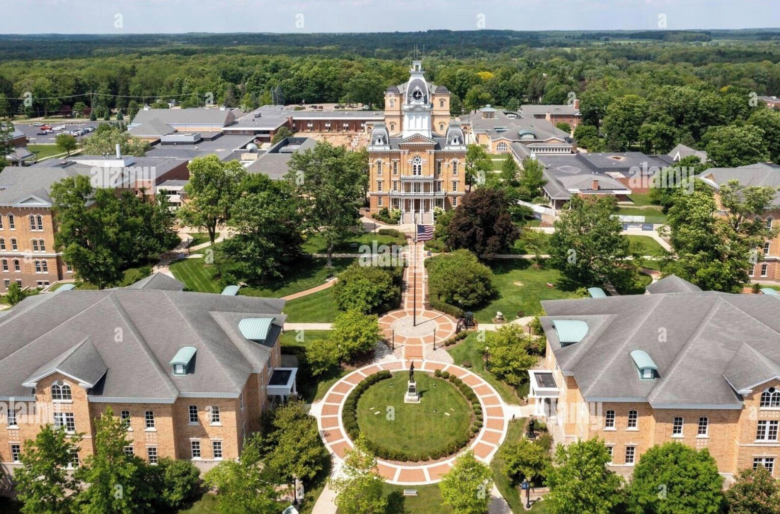 A large campus with multiple buildings, a central clock tower, and a circular courtyard.