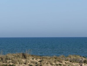 A coastal landscape with a sandy foreground and a calm sea under a clear sky. - MAYA - Héliopolis L 84 - Classic Category - 2 people (AGDE)