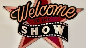 A star-shaped sign with the text "Welcome to the SHOW" on a white background. - Movie Night 100 Inch Screen, Walk to Bars and Restaurant (Reno)
