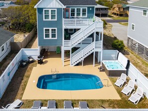 A two-story house with a backyard pool, a hot tub, and outdoor seating. - Rock Me on the Water: Oceanside, Pool, Hot Tub (Nags Head)