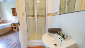 A bathroom with a shower, sink, and mirror. - 4 Bedroom Townhouse, Sleeps 6 with parking (Galway)