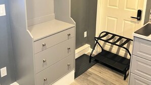 A room with a grey wardrobe, a white door, and a black chair. - Reno Spa Studio With Hot Tub and Sauna (Reno)