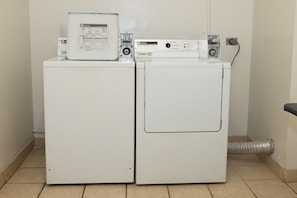 A laundry area with two stacked washers and dryers, a control panel, and a vent. - Kaanapali Shores | Ocean View 4 BR, Sleeps 12 | Car Incl. w/ 6+ Nights | KS ML-3677 by KBM (Lahaina)