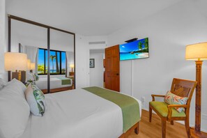 A hotel room with a bed, a chair, a TV, and a window with a view. - Kaanapali Shores | Ocean View 4 BR, Sleeps 12 | Car Incl. w/ 6+ Nights | KS ML-3677 by KBM (Lahaina)