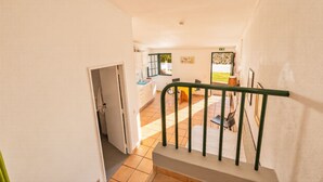 A staircase leading to a room with a bed, a desk, and a chair. - Ideal retreat for couples or small families (Fuseta)