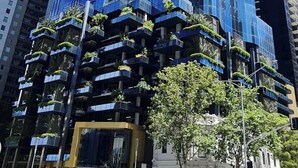 A tall, modern skyscraper with a distinctive angular design and reflective glass facade. - Modern 1-bedroom apartment with gym and pool access, centrally located near cafes, restaurants, and public transport—perfect for a comfortable city stay. (Southbank)