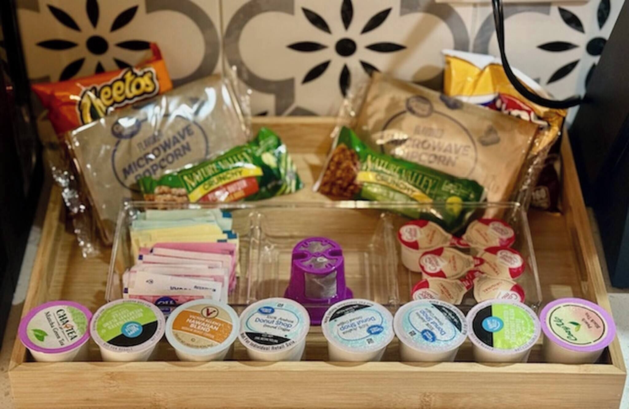 A snack tray with various packaged foods and yogurt containers.