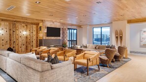 A spacious living area with a wooden ceiling, a large window, and a ski-themed wall decoration. - Mountain Dream at Frontgate by Avantstay Condo + Ski Shuttle Pool + Spa Access Mins to Beaver Creek (Avon)