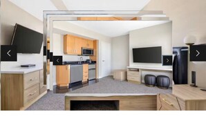 A modern kitchen with wooden cabinets, a microwave, and a sink. - Hilton Grand Vacations Club Elara Center Strip Las Vegas
1-bedroom suite (Las Vegas)