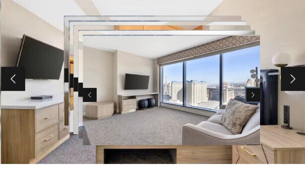 A modern hotel room with a large window, a flat-screen TV, a sofa, and a desk. - Hilton Grand Vacations Club Elara Center Strip Las Vegas
1-bedroom suite (Las Vegas)
