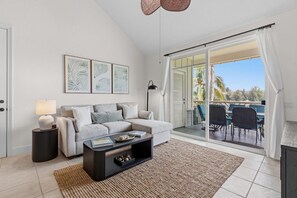 A modern living room with a sofa, coffee table, and artwork on the wall. - Top Floor Fairway Villas Condo | 2BR + Loft | Sleeps 8 | Golf Course Views (Waikoloa)
