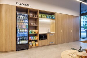 A modern pantry with shelves stocked with snacks, beverages, and condiments.