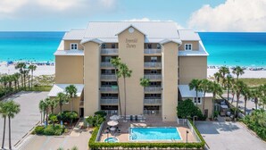 A hotel with a pool, beach view, and multiple balconies. - Beautiful Beachfront 3BR Condo with Pool! FREE Summer Beach Service! (Destin)