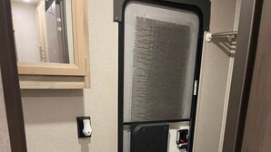 A compact bathroom with a sink, mirror, and toilet. - Come Settle in this cozy modern style RV, Nestled in the quiet country side. (Bushnell)