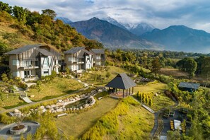 A modern resort with multiple buildings, a landscaped garden, and a mountain backdrop. - Norbu The Montanna, Dharamshala - Ihcl Seleqtions (Dharamshala)