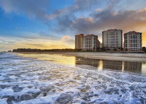 A beachfront hotel with multiple high-rise buildings, a sandy beach, and a calm sea. - Marriott's OceanWatch | Oceanfront 2 BR Villa (Myrtle Beach)