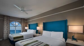 A hotel room with two beds, a ceiling fan, a large window with a view, and two bedside lamps. - Marriott's OceanWatch | Oceanfront 2 BR Villa (Myrtle Beach)