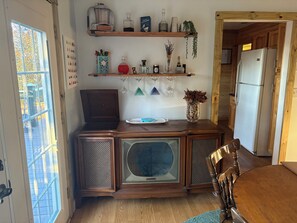A kitchen with wooden cabinets, a vintage radio, and a refrigerator. - Serene 3-bedroom bungalow with AC in charming Canton (Canton)
