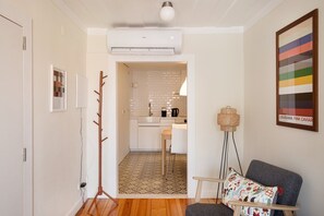A modern interior with a kitchen, a seating area, and a hallway. - Bright Alfama Studio with AC (Lisbon)